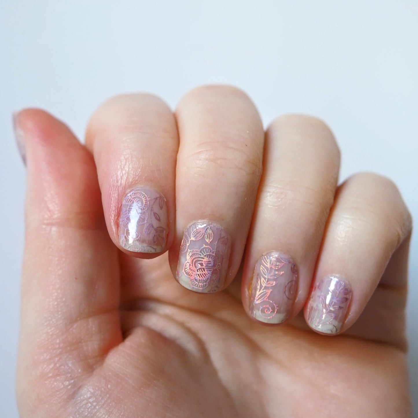 Subtle but beautiful iridescent rose pattern over natural nails.
