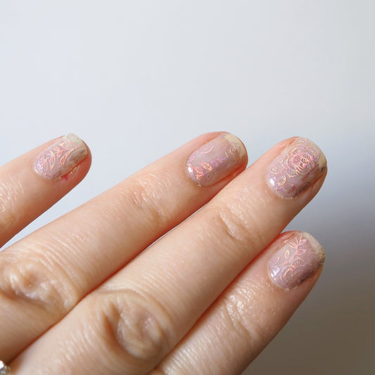 The semi-transparent Gilded Rose nail wraps on natural nails.