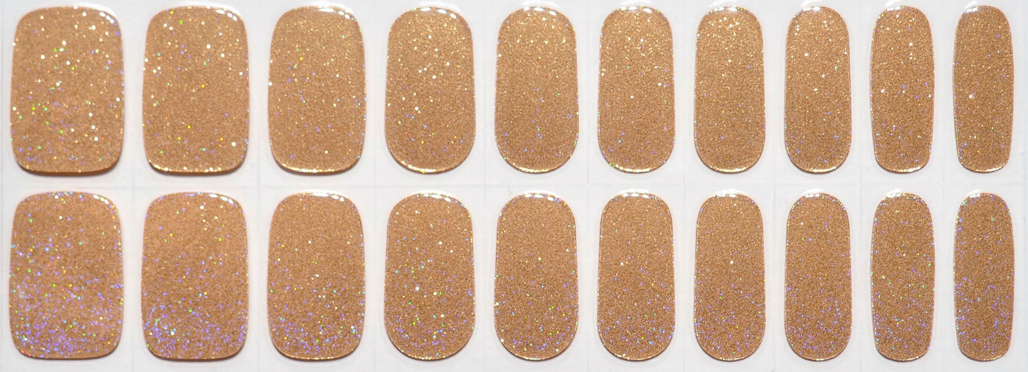 Glittery gold nail wraps with a magical rainbow shimmer.