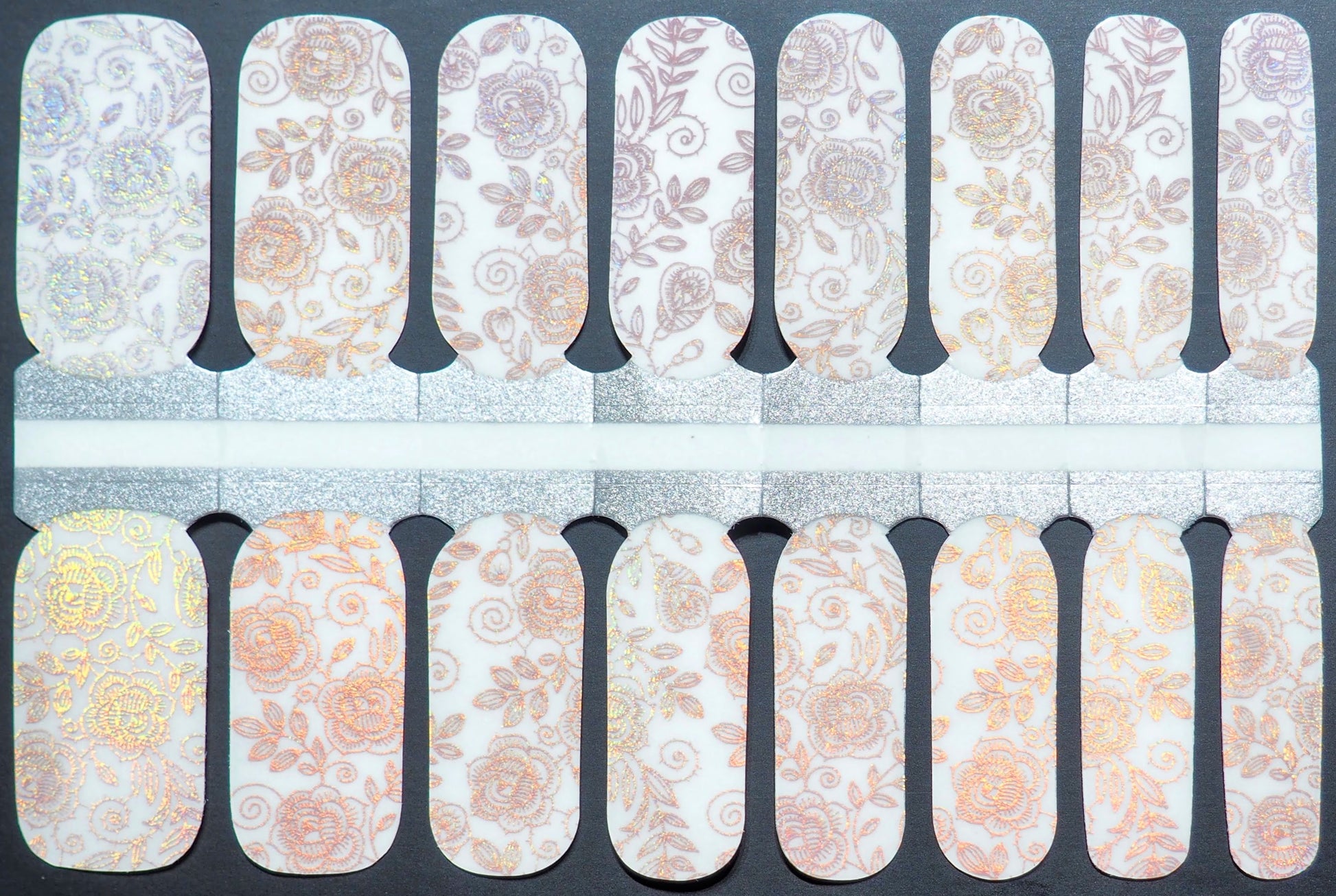 Semi-transparent nail wraps with iridescent rose patterns and gold accents.