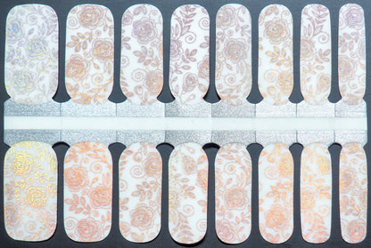 Semi-transparent nail wraps with iridescent rose patterns and gold accents.