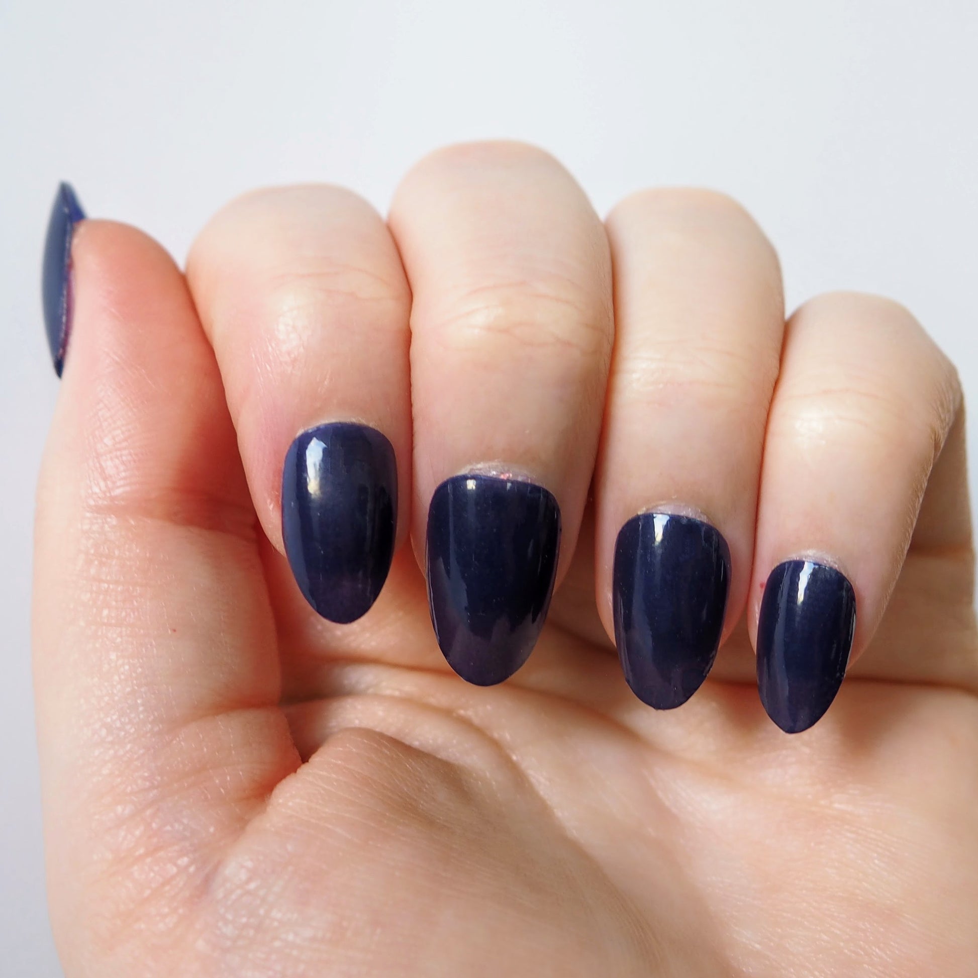 Deep navy blue nail wraps with a glossy gel-like finish.