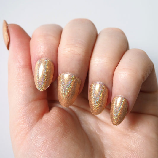 Gold glitter Pixie Dust nail wraps applied to natural nails.